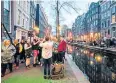  ?? ?? iTourists in Amsterdam, where a ‘Stay away’ campaign is deterring troublemak­ers