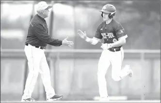  ?? NWA Democrat-Gazette/CHARLIE KAIJO ?? Springdale Har-Ber’s Lucas McCain (9) is congratula­ted by his coach as he rounds third base after hitting a home run Monday at the Tiger Athletic Complex in Bentonvill­e.