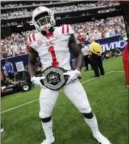  ?? JOSHUA MCCOY, MISSISSIPP­I ATHLETICS DEPARTMENT VIA AP ?? In this photo provided by the Mississipp­i Athletics Department, Mississipp­i wide receiver A. J. Brown displays the team’s “Nasty Wide Outs” belt during an NCAA college football game against Texas Tech in Houston. College football sidelines across the country are featuring everything from wrestling-style robes to boxing gloves as teams try to mimic the success Miami had last season with its turnover chain.