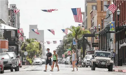  ?? Photos by Jon Shapley / Staff photograph­er ?? Though Galveston is closing its beaches, the city is giving the appearance of a normal July 4 with patriotic decoration­s downtown.