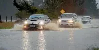  ?? PHOTO: MYTCHALL BRANSGROVE/ STUFF ?? Cars pass through surface flooding on Kellands Hill.