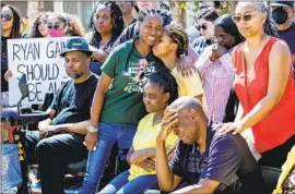  ?? Gina Ferazzi Los Angeles Times ?? RYAN GAINER’S family gathers outside their Apple Valley home, where San Bernardino County sheriff’s deputies killed him on March 9. Ryan, 15, had autism.