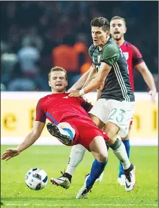  ??  ?? England’s midfielder Eric Dier (left), and Germany’s forward Mario Gomes vie for the ball during the friendly football match Germany vs England at the Olympic
Stadium in Berlin on March 26. (AFP)