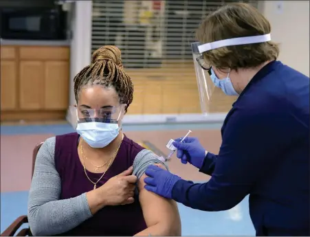  ?? SUBMITTED PHOTO ?? Shenita Clark, Unit Manager for 138A of the Community Living Center, became the first Coatesvill­e VA Medical Center employee to receive the COVID-19vaccine from Constance Fagan, a Registered Nurse.