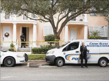  ?? ANDRES LEIVA / THE PALM BEACH POST ?? A Jupiter police crime technician exits her vehicle as an officer stands in front of a townhouse on Corbison Point Place in Jupiter’s Abacoa neighborho­od on Tuesday. A man and a woman were taken to the hospital after a stabbing at the house early...