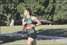  ??  ?? BOTTOM: SAN LUIS’S JENNIFER PERALTA runs during
Wednesday’s district meet.