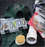  ?? Arkansas Democrat-Gazette/BRYAN HENDRICKS ?? The author’s backpack wade fishing kit consists of a small box of hard lures and a fanny pack full of soft plastic lures and terminal tackle. A two-piece ultralight fishing rod fits inside his custom-made PVC rod tube. A foam cap insert protects the rod tip.