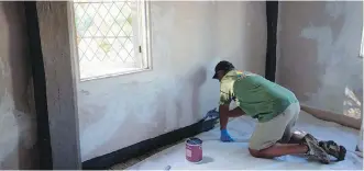  ??  ?? Left, a specialty craftsman repairs plaster on the walls at the James Blake House, before a fresh layer of paint is added.