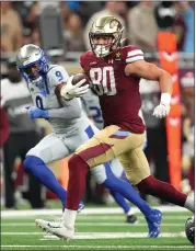  ?? PHOTO BY NIC ANTAYA/UFL — GETTY IMAGES ?? Cole Hikutini, 80, of the Michigan Panthers, runs the ball against Ben Deluca, right, of the St. Louis Battlehawk­s during the third quarter of the UFL opener at Ford Field on March 30 in Detroit.