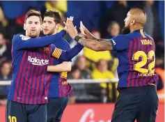  ?? — AFP photo ?? Barcelona’s Lionel Messi (left) celebrates with Arturo Vidal after scoring against Villarreal in a La Liga match at La Ceramica stadium in Vila-real. The match ended in a 4-4 draw.