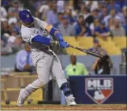  ?? MARK J. TERRILL — ASSOCIATED PRESS ?? Cubs’ Javier Baez hits a two-run scoring double during the eighth inning of Game 5.