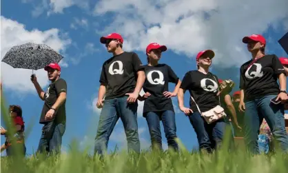  ?? ?? Supporters of Donald Trump wearing QAnon t-shirts wait in line before a campaign rally. Photograph: Sean Rayford/Getty Images