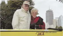  ?? PHOTO OF COURTESY OF NORTHEASTE­RN UNIVERSITY ?? FOREVER A HUSKY: Northeaste­rn legend Jack Grinold poses with his wife Cathy in front of the crew shell named in their honor after they establishe­d a $1.25 million endowment for the NU men’s rowing program in 2008 — one of many gifts Jack gave to the...