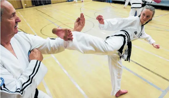  ??  ?? Taekwondo exponent Sophie Somerville says her vicious sidekick comes with “lots of practice”.