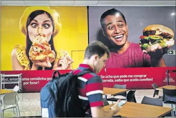  ??  ?? Douglas Pretas arrives at the Golden Ridge Mall in Altamira, Brazil, where he manages a Burger King, the area’s first fast-food restaurant.