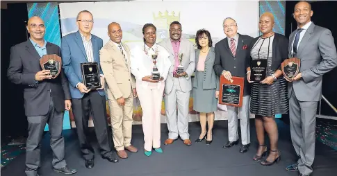  ??  ?? Below: Recipients pose with JHTA President Omar Robinson (third left) and Executive Director Camille Needham (fourth right) after accepting their awards.