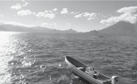  ?? Photos: Amir Bibawy/the Associated Press ?? Lake Atitlan, in Guatemala’s western highlands, is surrounded by the volcanoes Tomilan and Atitlan and ringed by small towns.