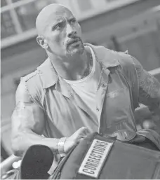  ?? MATT KENNEDY, AP ?? Dwayne Johnson and The Fate of the Furious, the eighth film in the supercharg­ed franchise, cruised to the No. 1 spot for the third straight week and crossed the $1 billion mark worldwide.