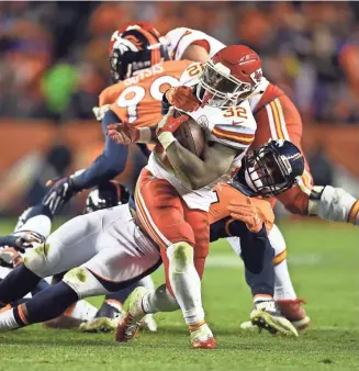  ?? RON CHENOY, USA TODAY SPORTS ?? Todd Davis tries to tackle Spencer Ware during the Broncos’ 30-27 overtime loss Sunday.