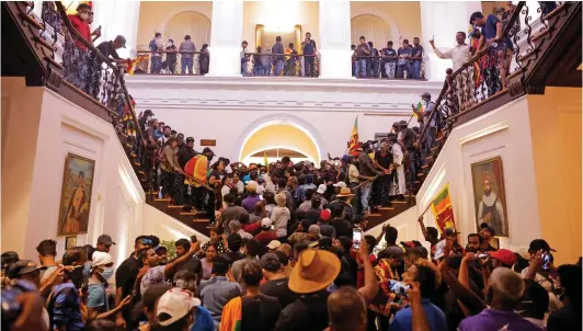  ?? ?? Pandemoniu­m: Hundreds of protesters occupy the grand staircase of the president’s house after storming the building