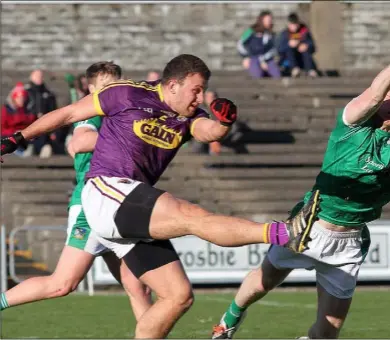  ??  ?? This thumping clearance by centre-back John Leacy set an attacking movement in train during Sunday’s merited