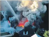 ?? WCVB THE ASSOCIATED PRESS ?? In this image take from video, flames consume the roof of a home in Lawrence, Mass., on Thursday.