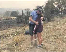  ?? HAVEN DALEY — THE ASSOCIATED PRESS ?? Kevin Conant and his wife, Nikki, hug after looking at the debris of their burnt home and business, “Conants Wine Barrel Creations,” after the Glass/Shady fire engulfed it on Wednesday, Sept. 30, in Santa Rosa, Calif.
