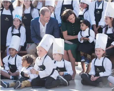  ?? JONATHAN HAYWARD, THE CANADIAN PRESS ?? The Duke and Duchess of Cambridge take delight at meeting young chefs during the Taste of British Columbia Festival at Mission Hill Winery in Kelowna on Tuesday.