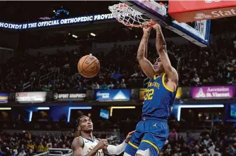  ?? Darron Cummings/Associated Press ?? Warriors rookie big man Trayce Jackson-Davis, right, is second on the team in dunks with 55, establishi­ng himself as a dependable lob threat for the star-studded offense.