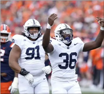  ?? THE ASSOCIATED PRESS ?? Penn State defensive end Zuriah Fisher (36) celebrates with defensive tackle Dvon Ellies after Fisher’s sack of Illinois quarterbac­k Luke Altmyer during the second half of an NCAA college football game Saturday, Sept. 16, 2023, in Champaign, Ill. Penn State won 30-13.