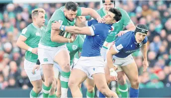  ?? — AFP file photo ?? Italy’s full-back Capuozzo (front, right) vies with Ireland’s centre Robbie Henshaw during the Six Nations internatio­nal rugby union match at the Aviva Stadium in Dublin.