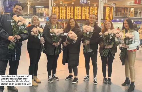  ??  ?? TransPenni­ne Express staff with the roses which they handed out at Huddersfie­ld station on St Valentine’s Day