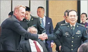  ??  ?? In this June 1 photo, acting U.S. Secretary of Defense Patrick Shanahan, left, shakes hands with Chinese Minister of National Defense Gen. Wei Fenghe, right, during a ministeria­l luncheon on the sidelines of the 18th Internatio­nal Institute for Strategic Studies (IISS) Shangri-la Dialogue in Singapore.