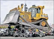  ?? Paul Martinka ?? A bulldozer crushing illegal dirt bikes.