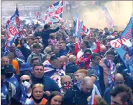  ??  ?? Fans are packed together as they head towards the city centre