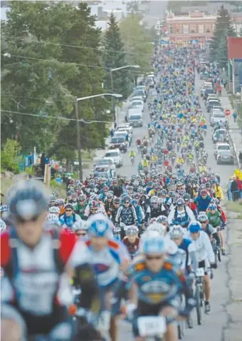  ?? Peter M. Fredin, Associated Press file ?? Competitor­s leave Leadville at the start of the Leadville Trail 100 mountain bike race in 2007. There were just 157 entrants in 1994. Now the race is capped at 1,850.