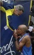  ?? CHARLES KRUPA, THE ASSOCIATED PRESS ?? Meb Keflezighi, right, of San Diego, who won the 2014 Boston Marathon, greets Bill Richard, father of 2013 marathon bombing victim Martin Richard.