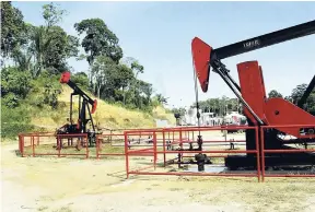  ??  ?? Oil equipment at work at the Petrotrin refinery in Trinidad and Tobago. The refinery is exiting production but plans to continue in business as an importer and distributo­r of petroleum products.