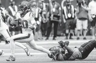  ??  ?? Texans safety Justin Reid runs past Jaguars wide receiver Laviska Shenault Jr. as he returns one of three intercepti­ons the team had against Lawrence on Sunday at NRG Stadium.