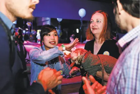  ?? Photos by Amy Osborne / Special to The Chronicle ?? Haight-Ashbury businesswo­man Christin Evans (second from right) was the driving force in the Yes on C campaign.