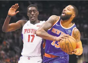  ?? Gregory Shamus / Getty Images ?? The Knicks’ Marcus Morris is defended by the Pistons’ Tony Snell on Wednesday night.
