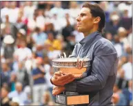  ?? Christophe Ena / Associated Press ?? Rafael Nadal celebrates his record 12th French Open title after beating Dominic Thiem in the men’s final on Sunday in Paris.