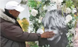  ?? ?? Donnie Green touches a photograph of late singer Tina Turner placed near her star on the Hollywood Walk of Fame in Los Angeles.