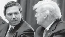  ?? EVAN VUCCI AP ?? Florida Gov. Ron DeSantis talks with then-President Donald Trump during a meeting with newly elected governors at the White House in December 2018.