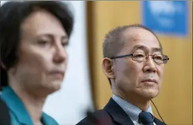  ?? MARTIAL TREZZINI — KEYSTONE VIA AP ?? Elena Manaenkova, left, WMO Deputy Secretary-General and Hoesung Lee, right, chair of the United Nations Intergover­nmental Panel on Climate Change (IPCC) Climate Change and Land after IPCC’s 50th session Thursday in Geneva, Switzerlan­d.