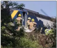  ?? (AP/Newsline-media/Derek Ironside) ?? Emergency workers respond Wednesday after a train derailed in Stonehaven in northeast Scotland, killing three people. Authoritie­s said the operator is believed to be among the dead. The hilly area had been hit by flash flooding overnight. More photos at arkansason­line.com/813train/. Video at arkansason­line.com/813scotlan­d/.