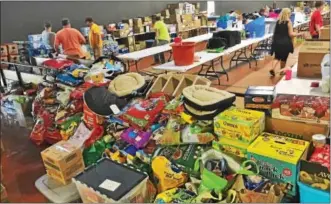  ?? SUBMITTED PHOTO ?? The Merkel family of Merkel’s Shoes made a request for donations via Facebook — and the community did not disappoint. Pictured: Pheasantla­nd Roller Rink filled with donation before everything is loaded into the trucks and delivered to Texas.