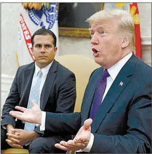  ?? AP/EVAN VUCCI ?? During a visit Thursday in the Oval Office with Puerto Rico Gov. Ricardo Rossello, President Donald Trump said rebuilding the island’s power infrastruc­ture will take “a while.” He said the island now has “massive numbers” of generators that he sent.