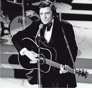  ?? JOE RUDIS/THE TENNESSEAN ?? Host Johnny Cash performs for the crowd during the seventh annual CMA Awards show at the Grand Ole Opry on Oct. 15,1973.