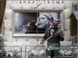  ?? ANDREW HARNIK, THE ASSOCIATED PRESS ?? A worker cleans the windows of the Ivanka Trump Collection in the lobby of Trump Tower in New York.